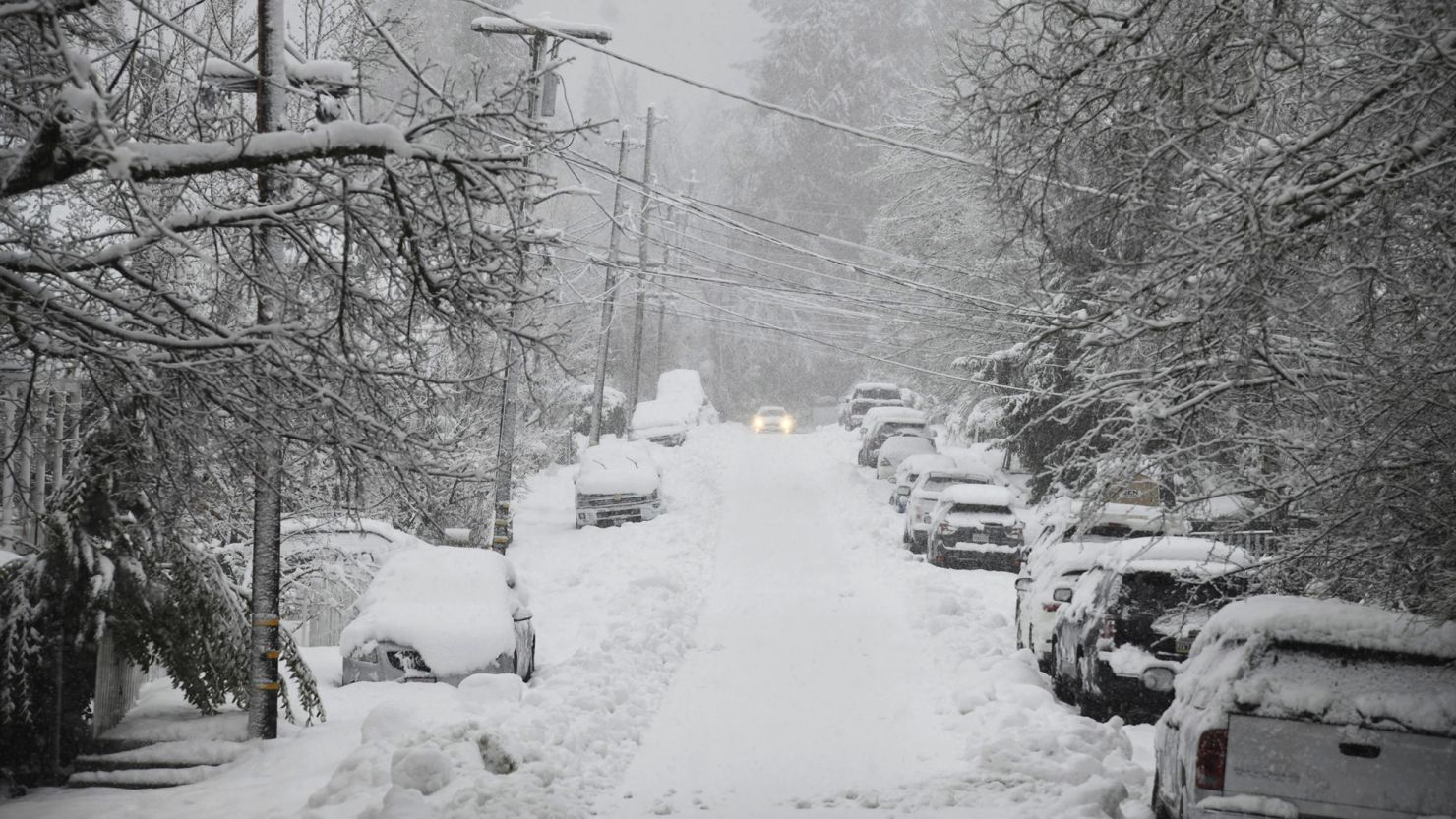 A vehicle attempts to drive along snow-covered Conaway Avenue in Grass Valley, California, during a snowstorm Tuesday. Parts of the state saw more than 3 feet of snow in just one day this week. 