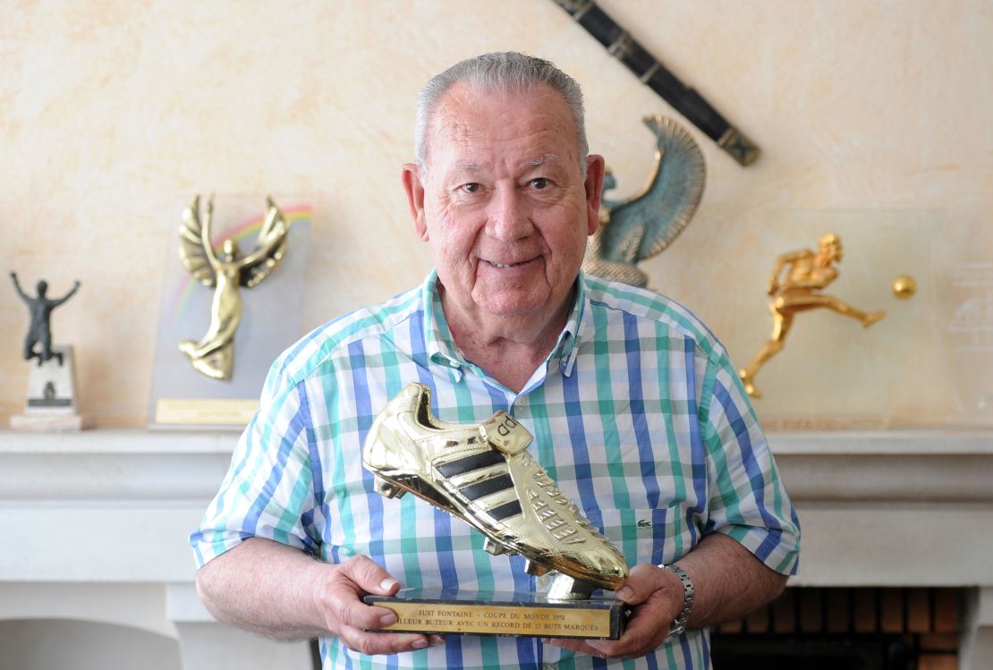 Just Fontaine poses with a trophy for the 1958 football World Cup top-scorer award.