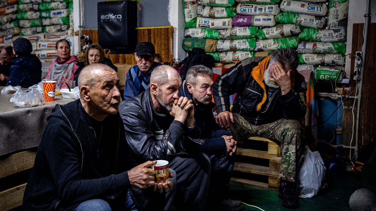 Ukrainians watch a movie on TV at a humanitarian aid centre in Bakhmut on Monday, amid waves of Russian attacks on the city.