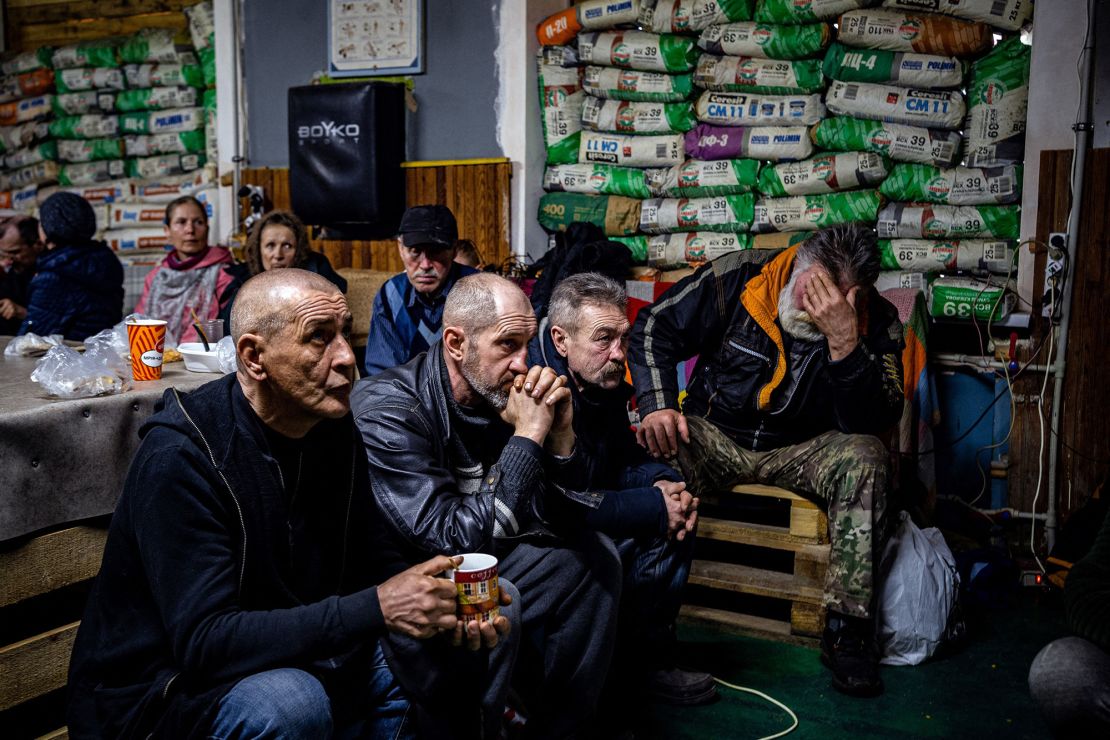 Ukrainians watch a movie on TV at a humanitarian aid centre in Bakhmut on Monday, amid waves of Russian attacks on the city.