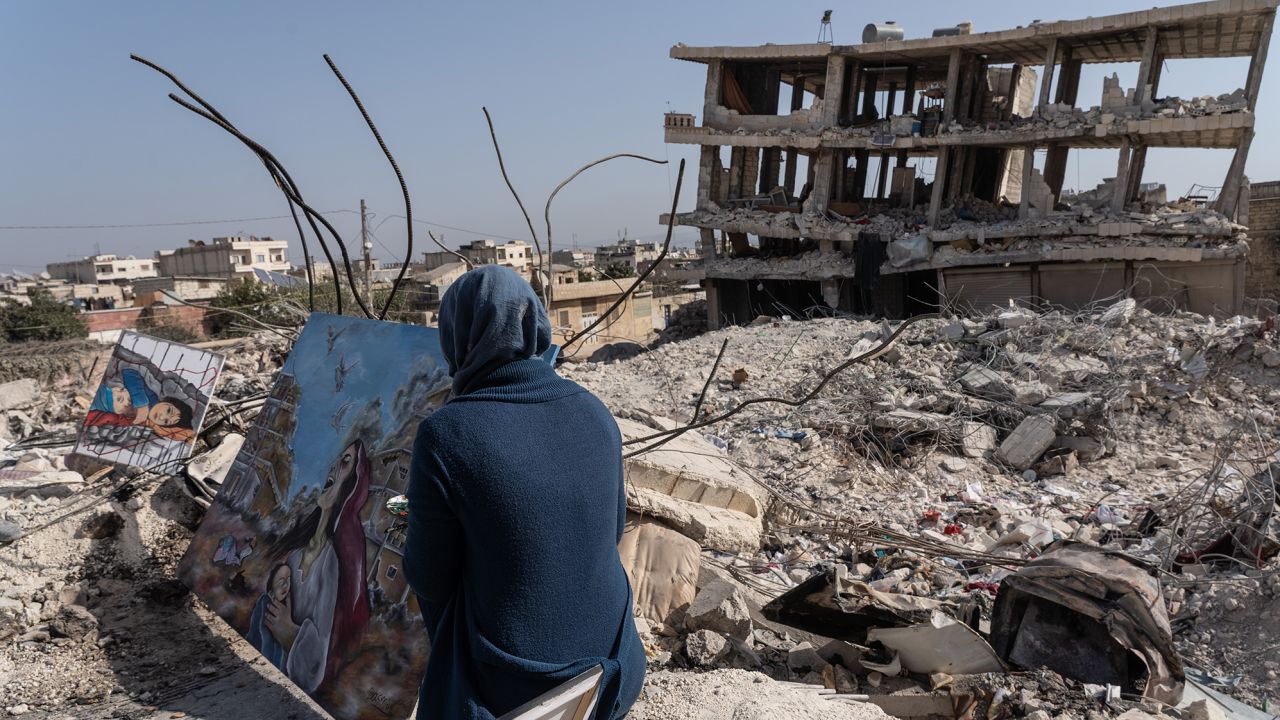 ALEPPO, SYRIA - FEBRUARY 28: Jasmine, 23 years old, paints amidst the rubble in the city of Jindires on February 28, 2023 near Aleppo, Syria. Jasmine lives in Afrin, a city near Jindires. Her paintings will be sold at auction with the proceeds to be donated to help the earthquake victims. A 7.8-magnitude earthquake hit near Gaziantep, Turkey in the early hours of February 6, followed by another 7.5-magnitude tremor just after midday. According to locals, almost 1,400 people died, and the city was badly damaged due to the earthquake. The quakes caused widespread destruction in southern Turkey and northern Syria and has killed more than 40,000 people. (Photo by Abdulmonam Eassa/Getty Images)