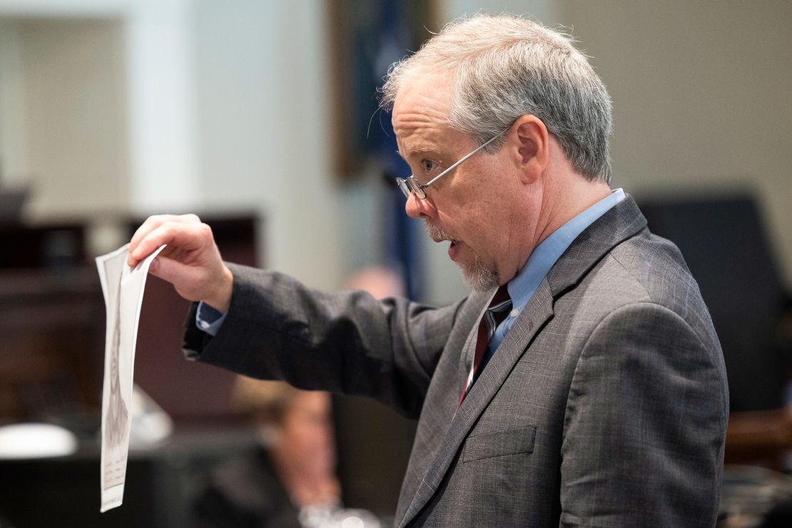 Prosecutor Creighton Waters holds up a composite sketch Alex Murdaugh helped make during closing arguments in Murdaugh's double murder trial on Wednesday.