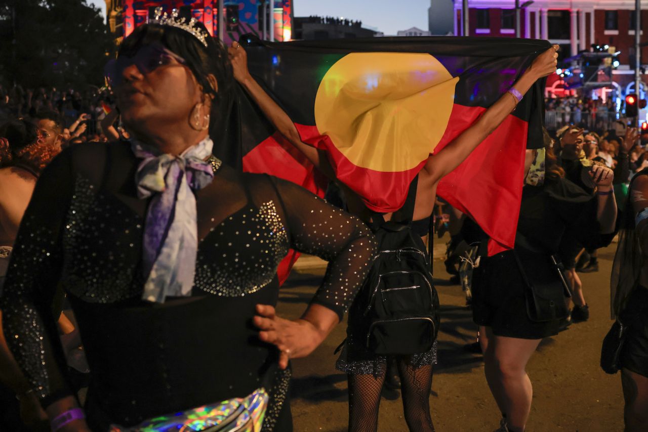 A parade goer holds up an Aboriginal flag while walking in the Sydney Gay & Lesbian Mardi Gras Parade as part of Sydney WorldPride on February 25, 2023 in Sydney, Australia.