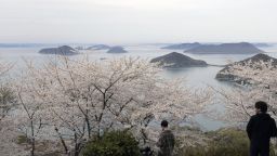 Cherry trees are in full bloom on Mt. Shiude in Mitoyo in Kagawa Prefecture, western Japan, on April 5, 2022, with isles in the Seto Inland Sea seen in the background. (Photo by Kyodo News via Getty Images)