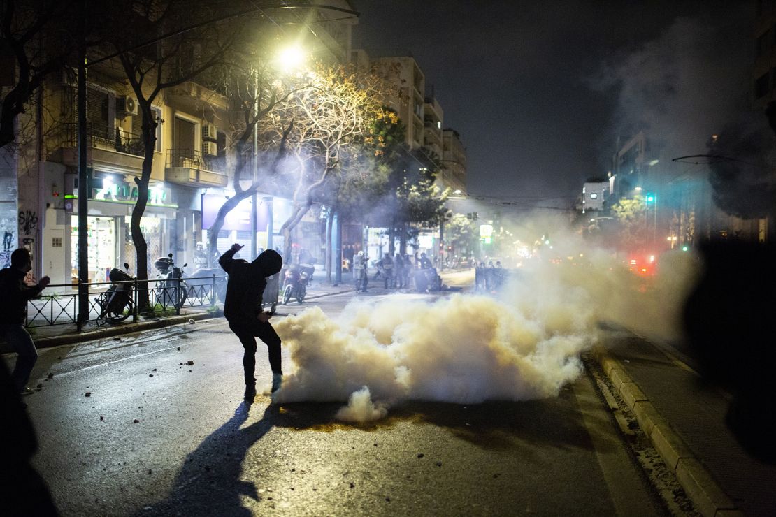 Protesters, pictured on Wednesday, clash with riot police on the streets of Athens, after Tuesday's collision killed dozens and left scores injured.