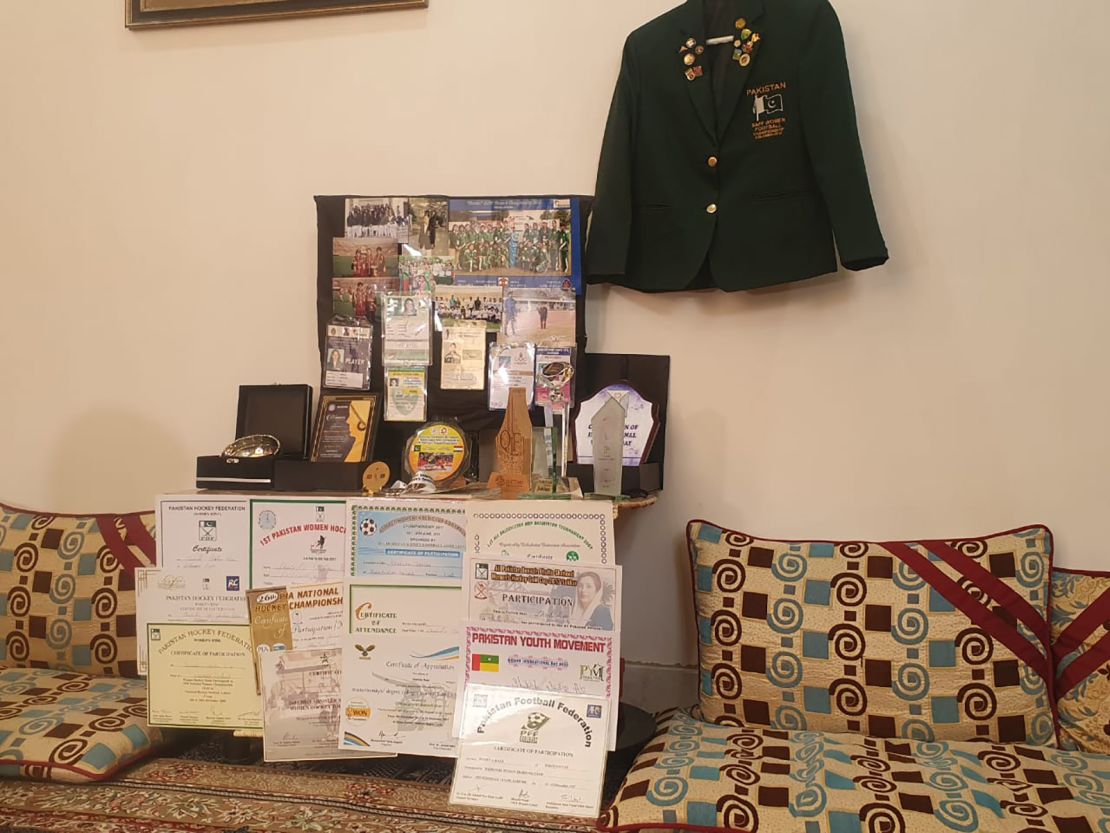 Medals, shields and certificates from Raza's sporting career are displayed in her family home.