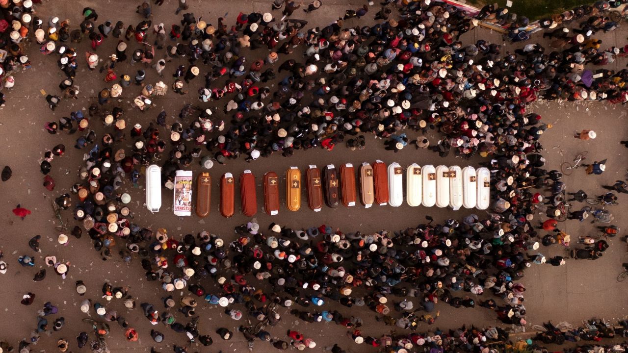 People surround the coffins of people who died during unrest in Juliaca, Peru.