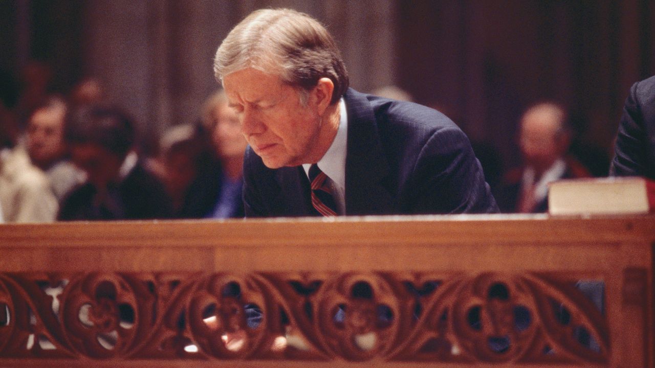 US President Jimmy Carter (left) bows during an Interfaith Prayer Service (held in honor of the hostages being held in Iran) at the Washington National Cathedral, Washington DC, November 15, 1979.