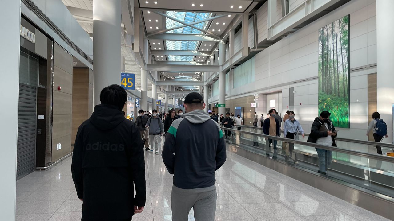 Two of the five Russians, pictured at South Korea's Incheon International Airport on January 24, 2023.