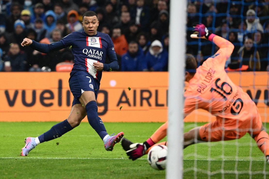 TOPSHOT - Paris Saint-Germain's French forward Kylian Mbappe scores his team's third goal during the French L1 football match between Olympique Marseille (OM) and Paris Saint-Germain (PSG) at the Velodrome stadium in Marseille, southern France on February 26, 2023. (Photo by CHRISTOPHE SIMON / AFP) (Photo by CHRISTOPHE SIMON/AFP via Getty Images)