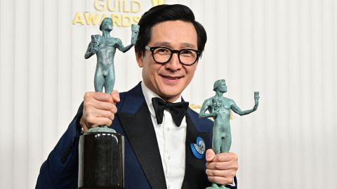 Ke Huy Quan poses with the awards for outstanding male actor in a supporting role - motion picture and outstanding performance by a cast in a motion picture for his part in 