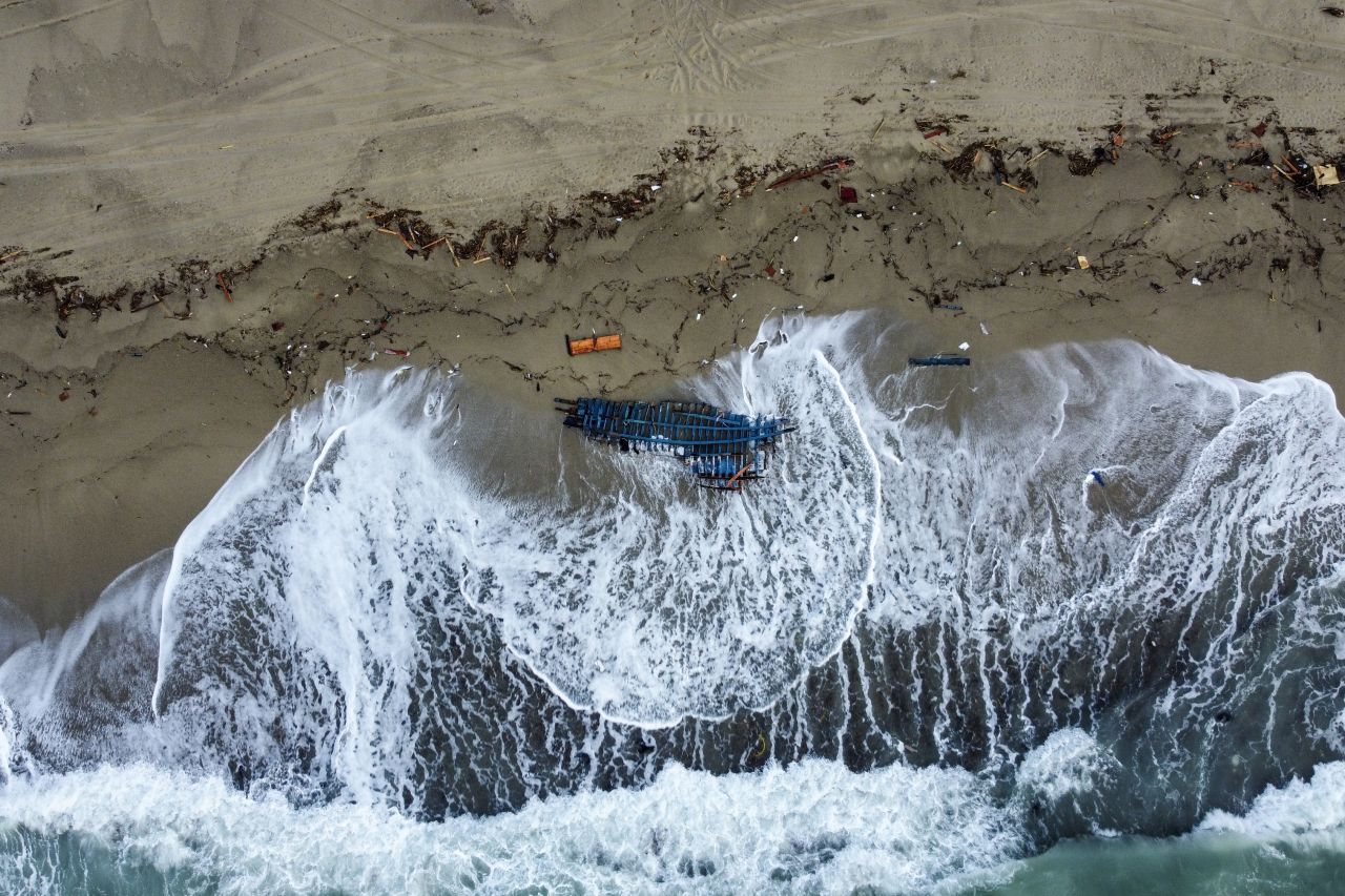 Wreckage from a capsized boat is washed ashore on a beach near Cutro, Italy, on Monday, February 27. At least 64 people died after the wooden boat carrying migrants from Turkey broke apart on rocks off the Italian coast on Sunday.