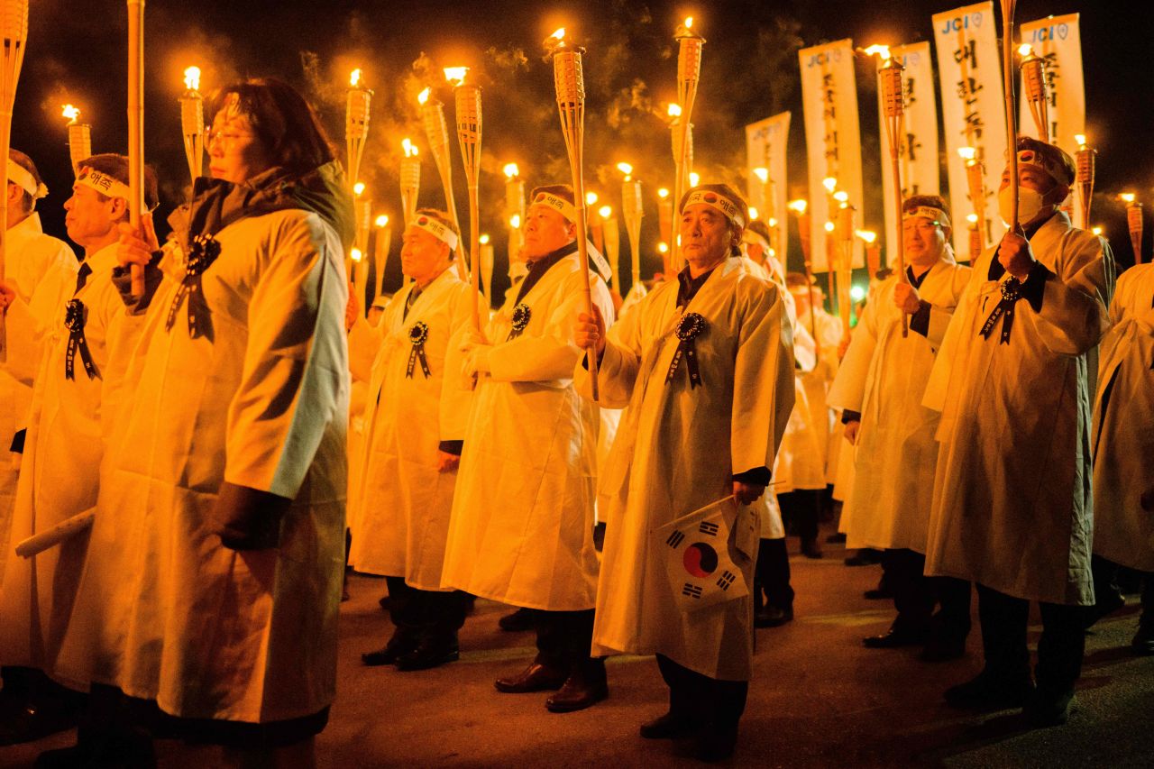 Participants wear traditional costumes and hold torches while marching to celebrate the Independence Movement anniversary in Cheonan, South Korea, on Tuesday, February 28. The holiday marks the 1919 civilian uprising against Japanese colonial rule.