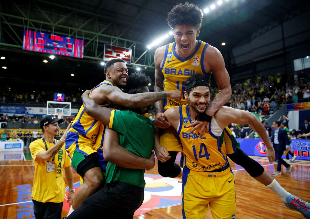 Brazil's Guilherme Santos celebrates with teammates after defeating the United States on Sunday, February 26, to qualify for the Basketball World Cup.