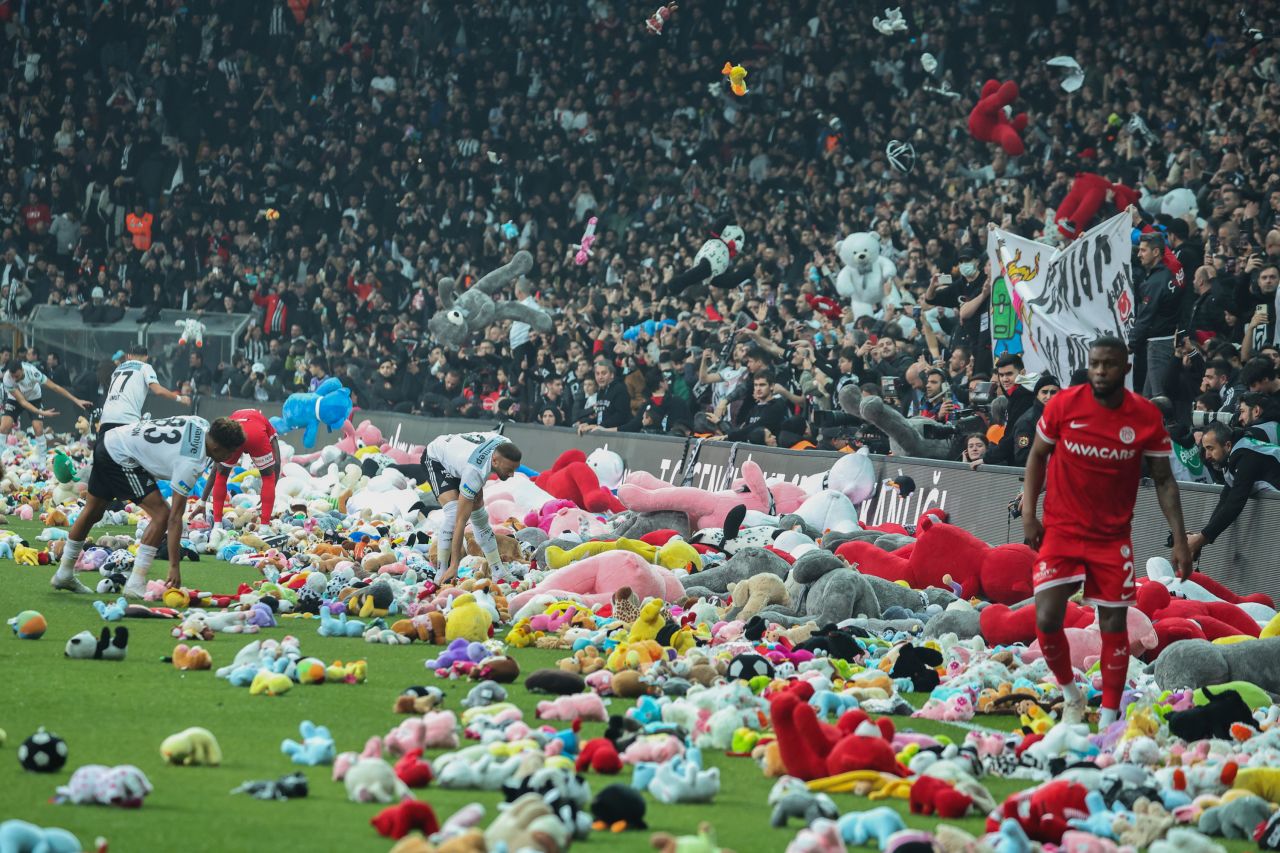 Fans throw toys onto the pitch during the Turkish Super League soccer match between Besiktas and Antalyaspor in Istanbul, Turkey, on Sunday, February 26. During the match, supporters threw a massive number of toys to be donated to children affected by the powerful earthquake that hit the country in early February.