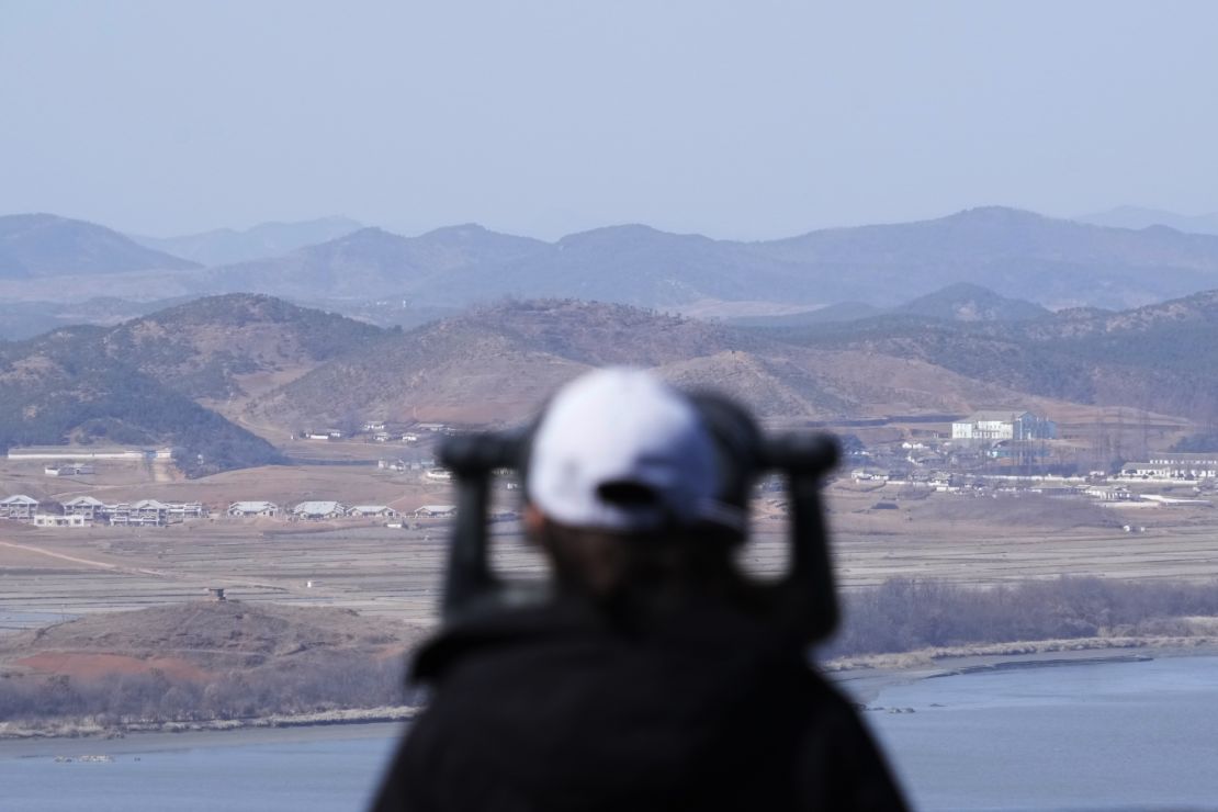 A visitor looks over the border between South and North Korea from the Unification Observation Post in Paju, South Korea.