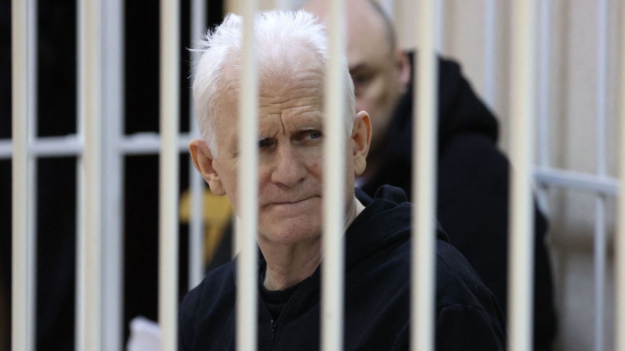 Nobel Prize winner Ales Bialiatski is seen in the defendants' cage in the courtroom at the start of the hearing in Minsk on January 5, 2023. 