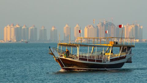 A dhow boat sails across Doha Bay.