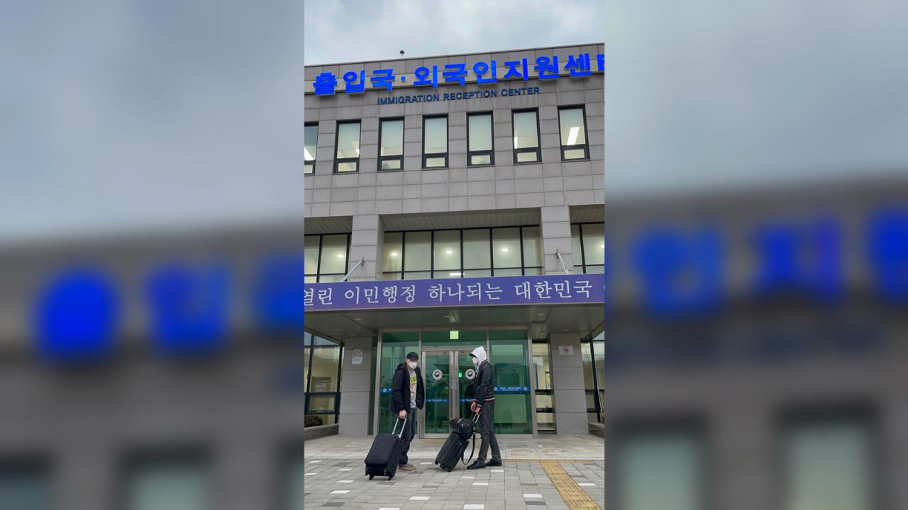 Russians seeking asylum are seen in front of the Immigration Reception Center in South Korea. This picture has been blurred by CNN.