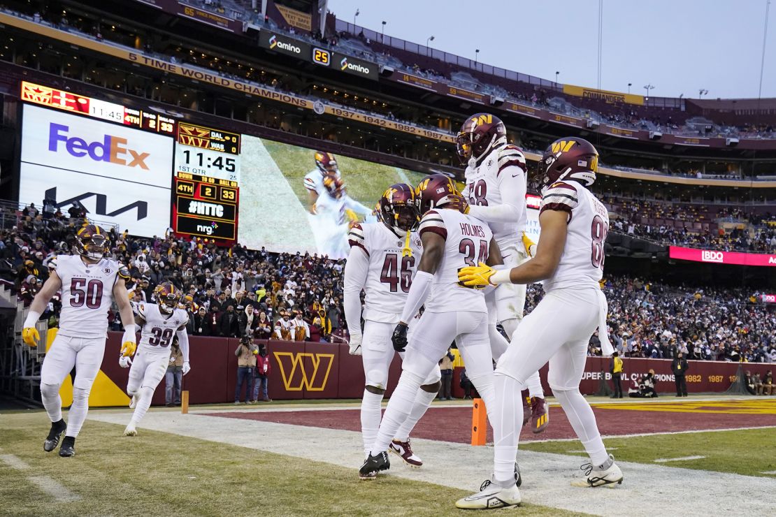 The Washington Commanders celebrate after Milo Eifler completes a play during the first half of the game against the Dallas Cowboys at FedExField on January 8, 2023.