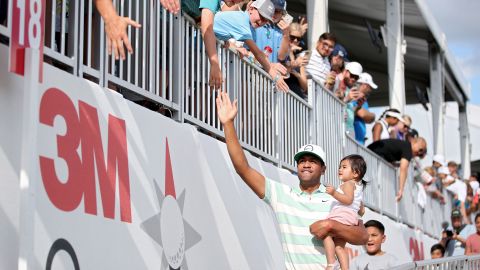 Finau celebrates victory at the 3M Open with his family in July 2022.
