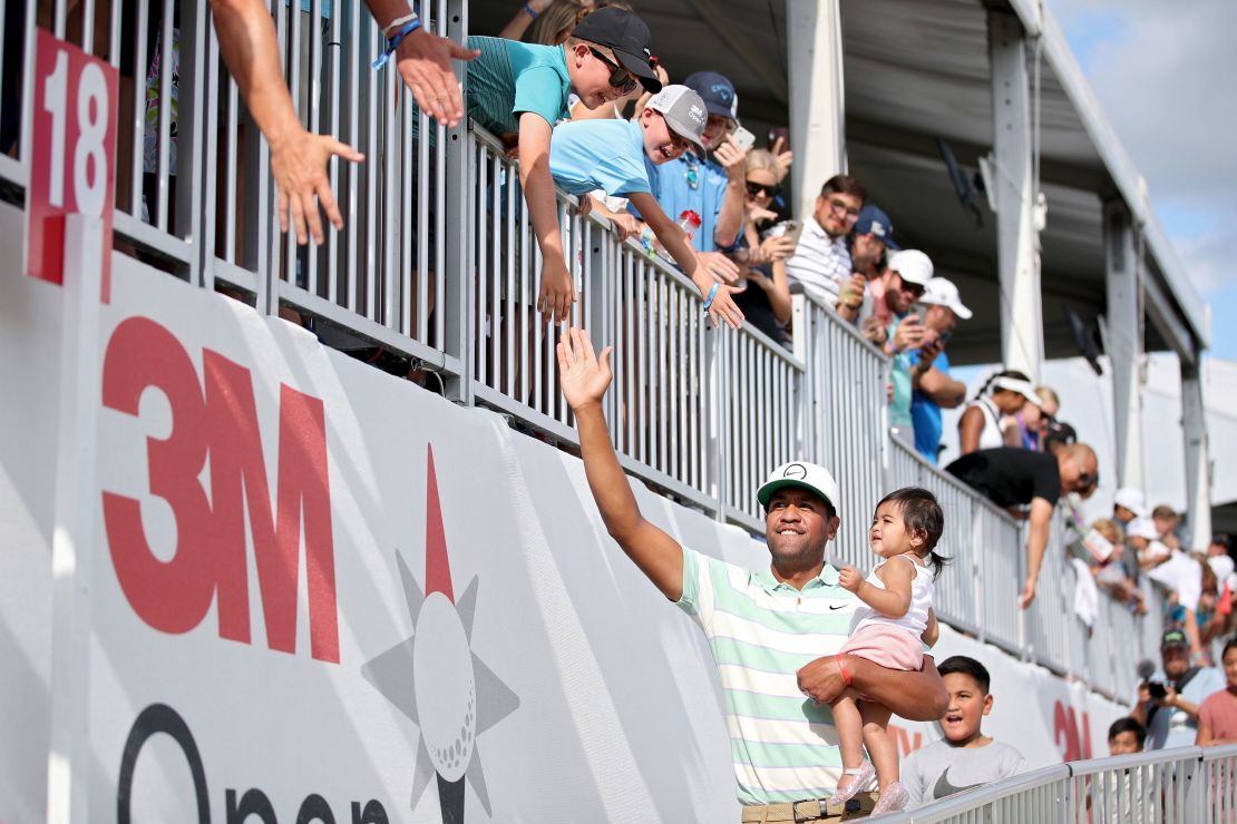 Finau celebrates victory at the 3M Open with his family in July 2022.