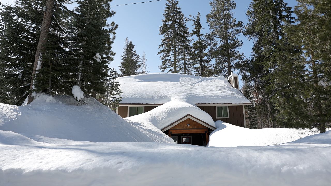 A home is seen buried in snow on Friday in Twin Bridges, California.
