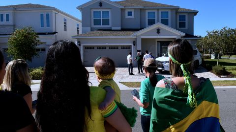 Supporters of Bolsonaro stand in front of the home he is staying in, hoping he will emerge, in Kissimmee, Florida.