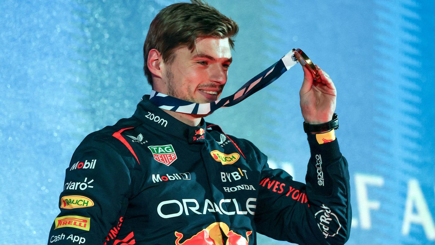 Red Bull Racing's Dutch driver Max Verstappen holds up his medal on the podium after winning the Bahrain Formula One Grand Prix at the Bahrain International Circuit in Sakhir on March 5, 2023. 