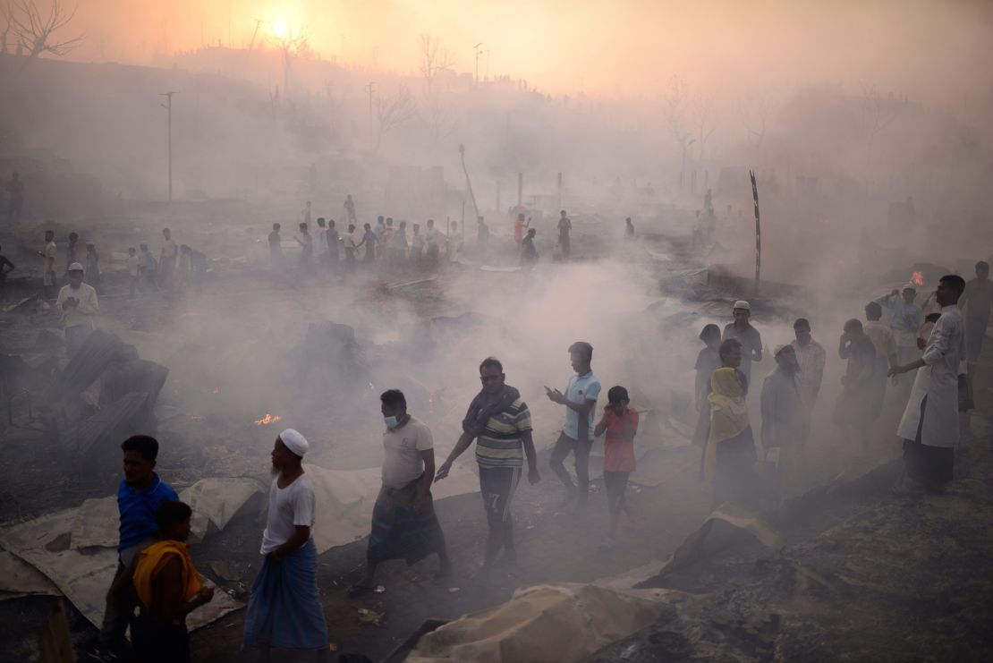 Rohingya refugees try to salvage their belongings after the major fire ripped through the camp.