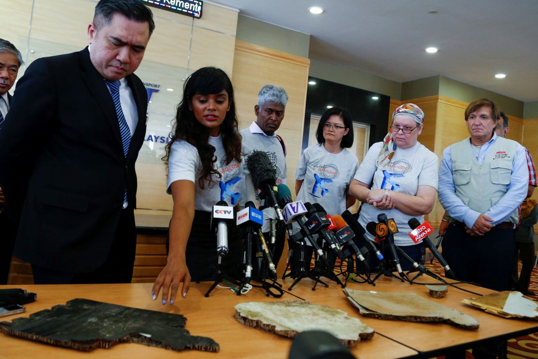 Grace Subathirai Nathan (2nd L), daughter of MH370 passenger Anne Daisy, shows to Malaysia's Transport Minister Anthony Loke (L) pieces of debris found in Madagascar, believed to be from flight MH370 before handing over to him in Putrajaya on November 30, 2018.