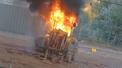 A construction vehicle burns Sunday at the site of a planned police training facility in Atlanta.