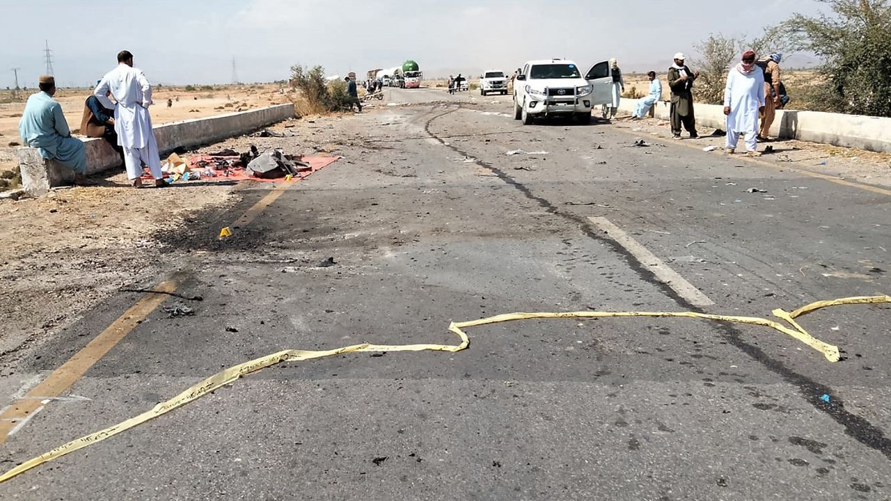 Security officials examine the site after a fatal suicide blast on a police truck in Balochistan, southwestern Pakistan on March 6, 2023, as attacks targeting security personnel have risen in the country.