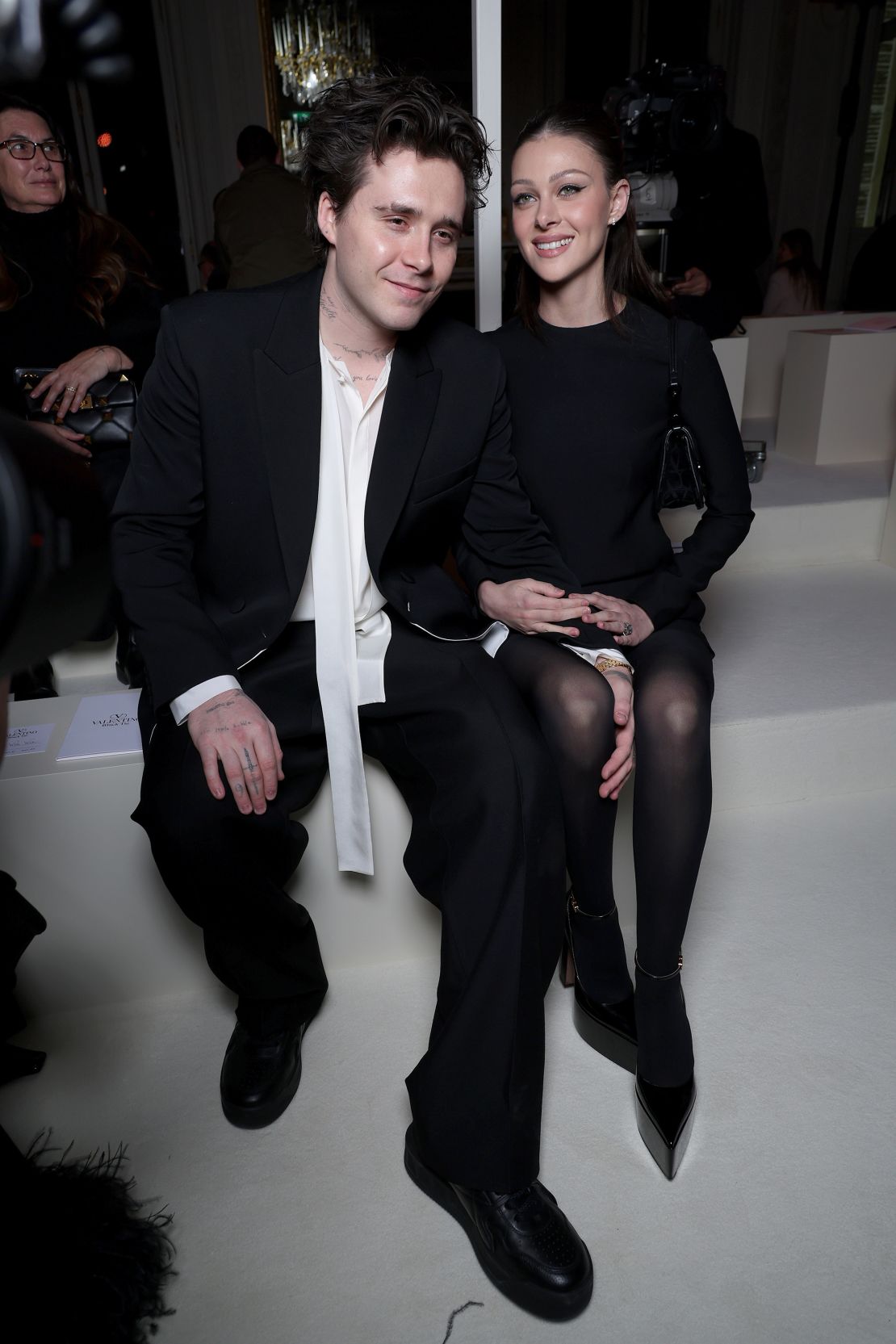 Brooklyn Beckham and Nicola Peltz seated at the Valentino show on March 5, 2023.