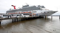 FILE -Passengers disembark from the Carnival Sunshine cruise ship Monday, March 16, 2020, in Charleston, S.C. (AP Photo/Mic Smith, File)