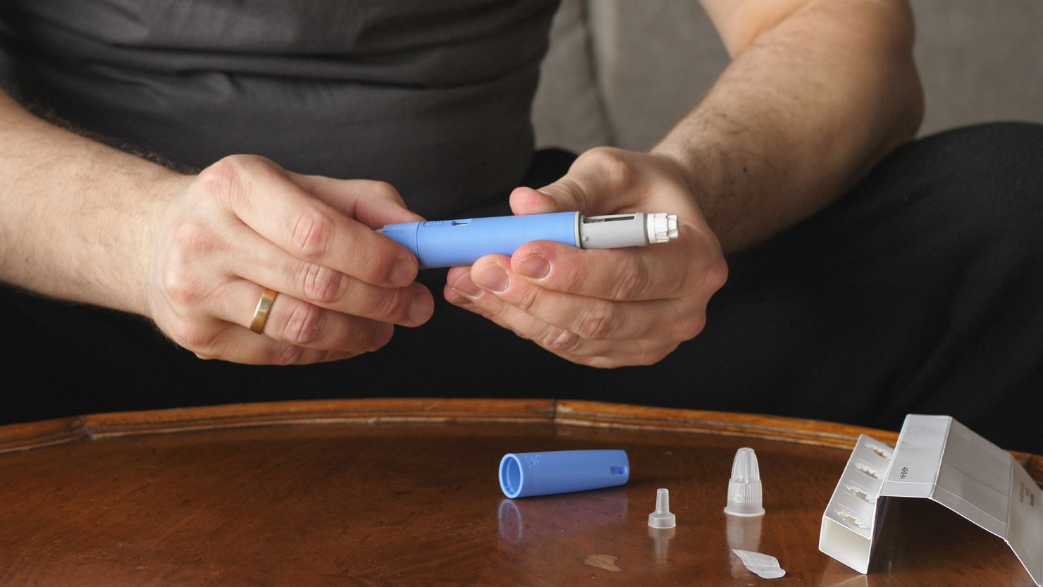 A man prepares a Semaglutide Ozempic injection