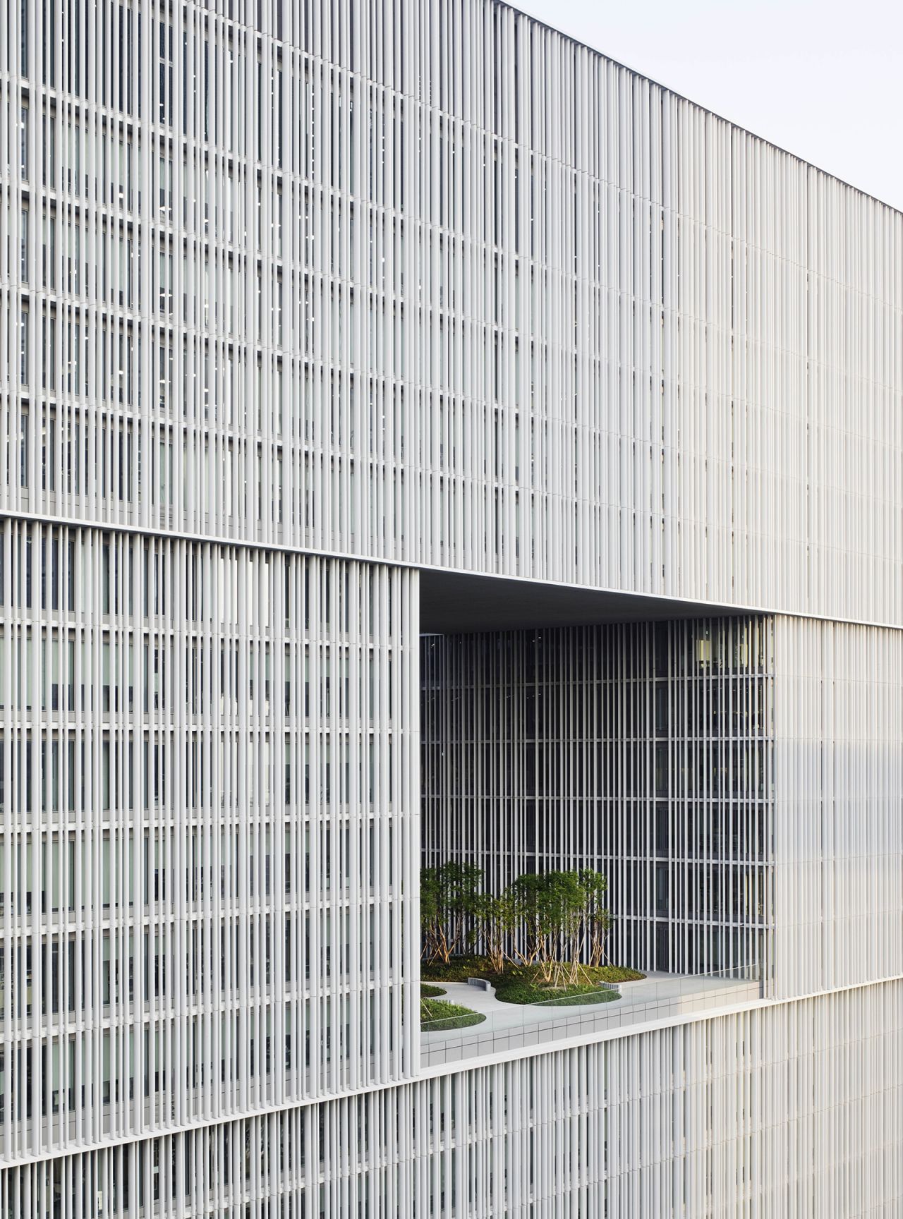 Vertical aluminum fins pass across the glass facade of the David Chipperfield-designed headquarters for beauty firm Amorepacific, in Seoul, South Korea.
