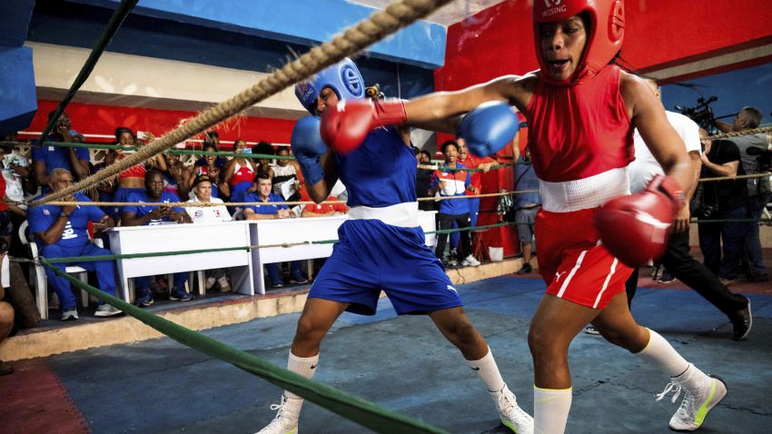Cuban boxers fight during the first official women's boxing program in Cuba at the Giraldo Cordova boxing school in Havana, on December 17, 2022. - With a strong right jab to the face of his opponent, Elianni García Polledo (50kg), decided this Saturday the first official women's boxing match in Cuba, a day awaited for decades by the women of the island. (Photo by YAMIL LAGE / AFP) (Photo by YAMIL LAGE/AFP via Getty Images)