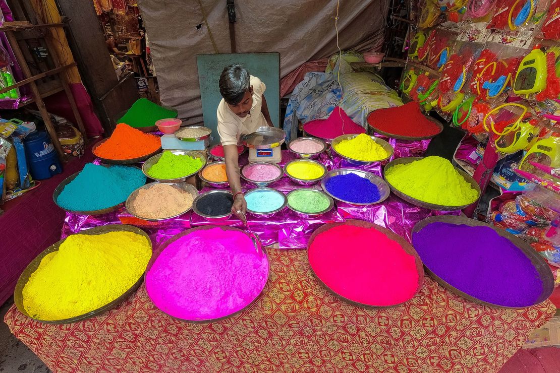 A vendor organizes colored powders for sale ahead of Holi in Kolkata, India, on March 3, 2023.