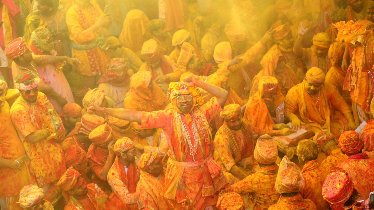 Devotees smear each other with colors in celebration of Holi on February 27, 2023.