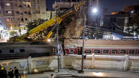 A crane is deployed to lift a derailed train at the scene of a railroad accident in the city of Qalyub in Qalyub province, in Egypt's Nile delta region north of the capital on March 7, 2023.