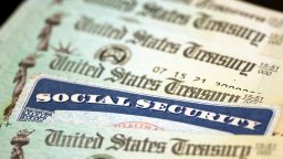 In this photo illustration, a Social Security card sits alongside checks from the U.S. Treasury on October 14, 2021 in Washington, DC.
