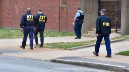 Alcohol, Tobacco, & Firearms agents alongside a FBI agent and a St. Louis metropolitan police officer, walk outside the north side of the Central Visual and Performing Arts High School after a shooting that left three people dead including the shooter in St Louis, Missouri on October 24, 2022. - Two people were killed on Monday and several were injured by a gunman who opened fire at a high school in the midwestern US city of St. Louis, police said. (Photo by TIM VIZER / AFP) (Photo by TIM VIZER/AFP via Getty Images)