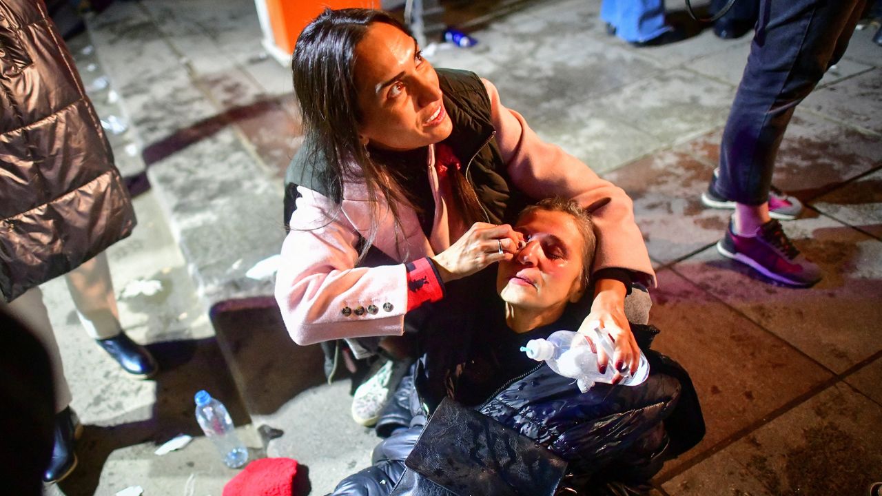 A woman affected by tear gas receives medical aid during a rally against the "foreign agents" law in Tbilisi, Georgia, March 7.