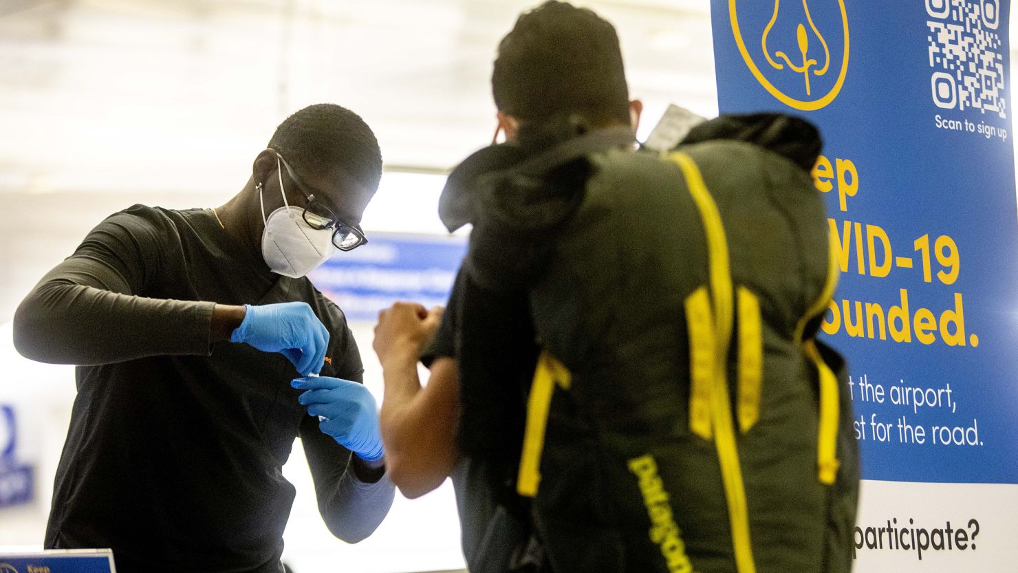 A healthcare worker labels a Covid-19 test from an international traveler at a CDC Covid-19 variant testing site inside Tom Bradley International Terminal at Los Angeles International Airport (LAX) in Los Angeles, California, US, on Jan. 9, 2023. An official told CNN that the US could relax Covid testing restrictions for travelers from China as soon as Friday. 