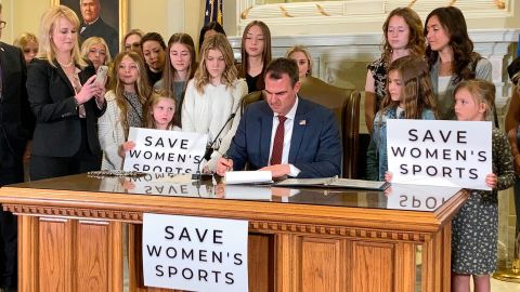 Oklahoma Gov. Kevin Stitt signs a bill on March 30, 2022, that prevents transgender girls and women from competing on female sports teams.