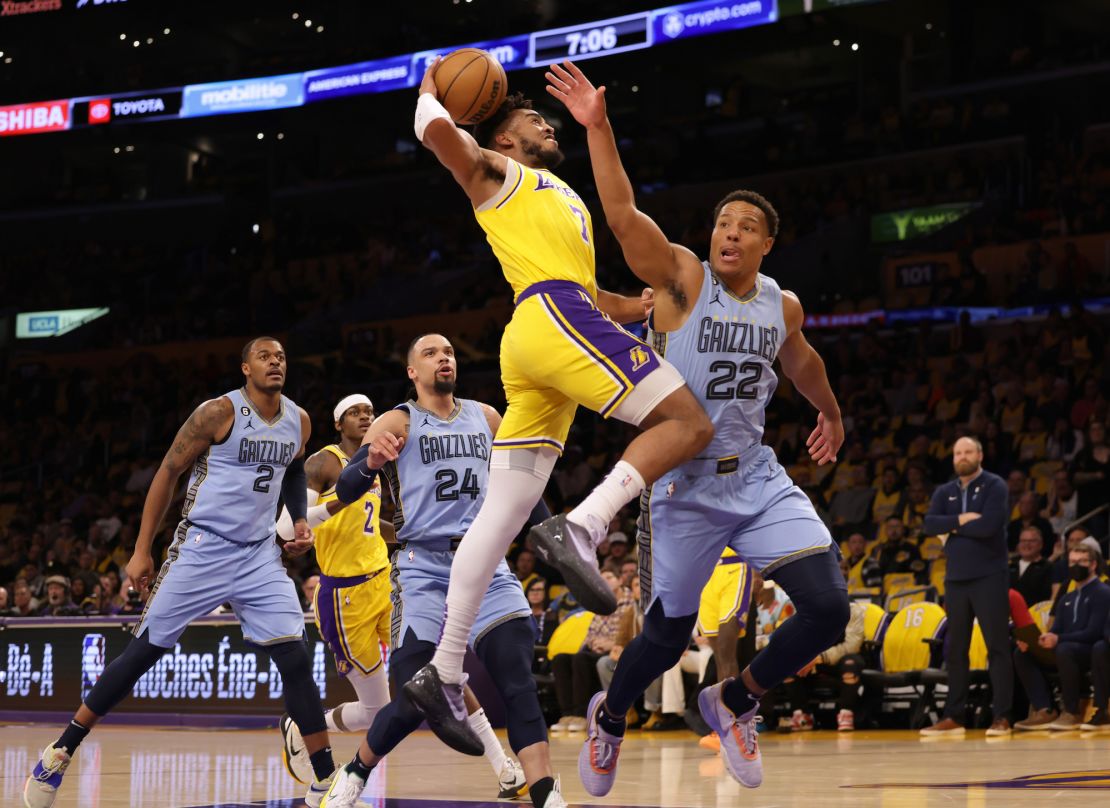 Lakers forward Troy Brown Jr. is fouled by Desmond Bane of the Grizzlies as he attempts a layup.