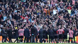 Brentford fans celebrate after their away win against reigning Premier League champions Manchester City.
