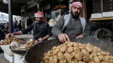 A merchant sorts through desert truffles at a stall in a market in the city of Hama in west-central Syria on Monday. Between February and April, hundreds of impoverished Syrians search for 