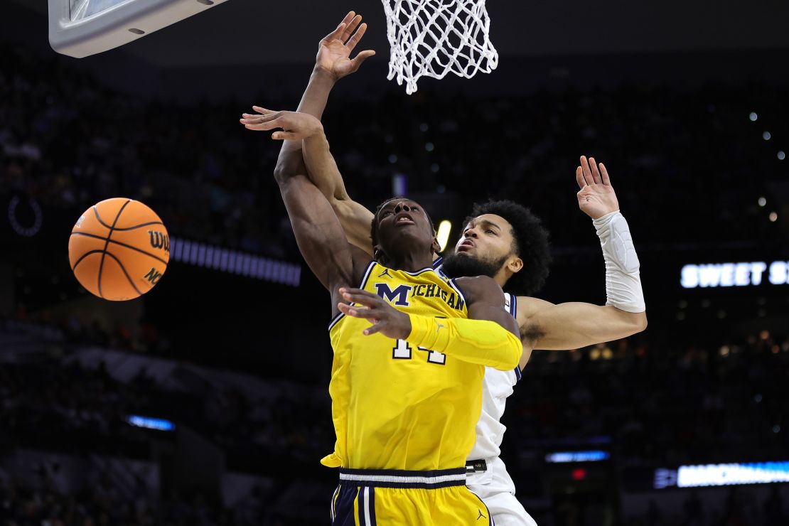 Caleb Daniels of the Villanova Wildcats blocks a shot by Moussa Diabate of the Michigan Wolverines during the second half of their Sweet 16 game in 2022.